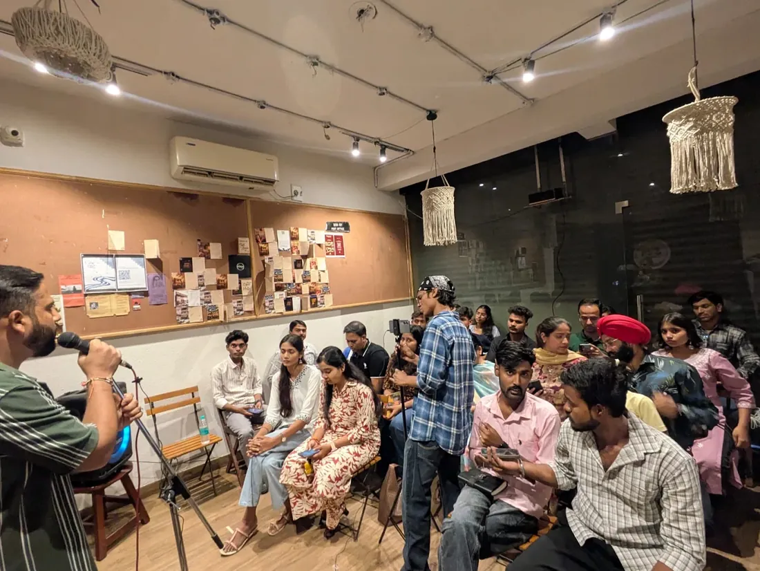 Guests listening to a performer at an open mic night at Highbrooks
